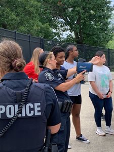 Police teaching young woman about Law Enforement