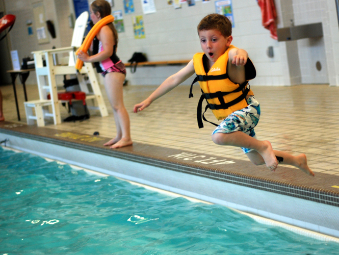 Kids jumping in pool