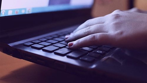 hands on a laptop keyboard